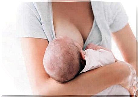 A woman breastfeeding her baby.