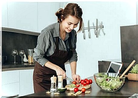 A woman cooking a salad. 