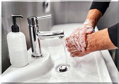 A person washes their hands.