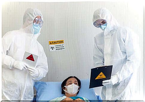 Two healthcare professionals treating a patient with coronavirus