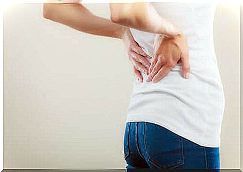 A woman has back pain.